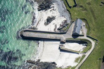 Oblique aerial view of Hynish Harbour on the Isle of Tiree, looking SSE.