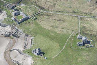 Oblique aerial view of Breachacha House and castle on the Isle of Coll, looking NNW.