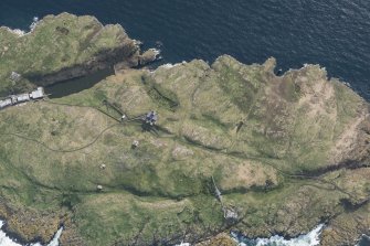Oblique aerial view of the New Lighthouse, The Beacon, Lighthouse and Keepers Cottage and remains of the Port War Signal Station on the Isle of May, looking SW.