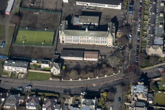 Oblique aerial view of St John's RC Primary School, looking NNW.