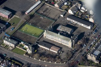 Oblique aerial view of St John's RC Primary School, looking NW.