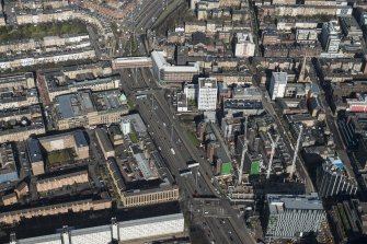 Oblique aerial view of Charing cross, the M8 at St Vincent Street junction and the Mitchell Library, looking N.