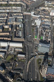 Oblique aerial view of Charing cross, the M8 at St Vincent Street junction and the Mitchell Library, looking NNW.
