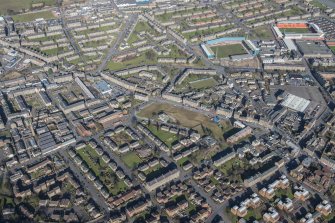 Oblique aerial view of The Hilltown, Mortimer Street, the churches, Dens Park and Tannadice Park, looking NE.