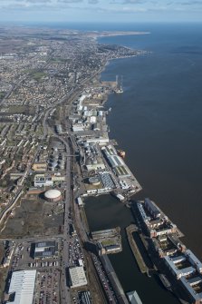 General oblique aerial view of the harbour area of Dundee centred on Camperdown Dock and King V Wharf, looking E.