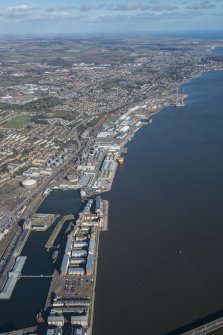 General oblique aerial view of the harbour area of Dundee centred on Camperdown Dock and King V Wharf, looking NNE.