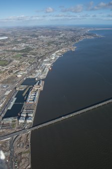 General oblique aerial view of the harbour area of Dundee centred on Camperdown Dock and King V Wharf, looking E.