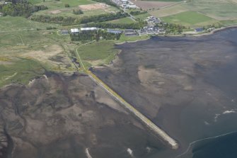 Oblique aerial view of fishing stands on the River Alness, Dalmore Distillery and pier, looking NNW.