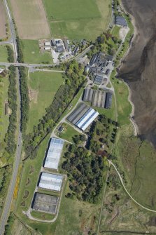 Oblique aerial view of Dalmore Distillery, looking NE.