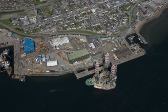 Oblique aerial view of Invergordon harbour and oil rig service base, looking N.