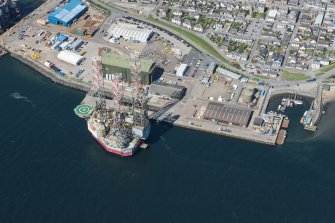 Oblique aerial view of Invergordon harbour and oil rig service base, looking NNW.