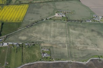 Oblique aerial view of the soilmarks at Polnicol, looking NW.