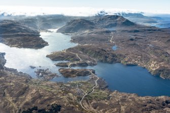 General oblique aerial view centred on Kylesku with Cnoc na Creige and Glas Bheinn beyond, looking SE.