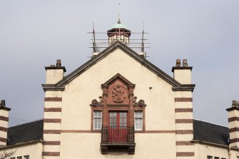 Detail of second floor balcony, chimney stacks and bellcote on south east facing elevation.