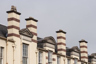 Detail of chimney stacks and pediments on east facing elevation..