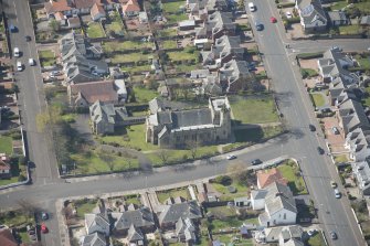 Oblique aerial view of the Chapel of our Lady of the Assumption and St Meddan Church, looking SW.