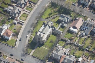 Oblique aerial view of the Chapel of our Lady of the Assumption and St Meddan Church, looking SE.
