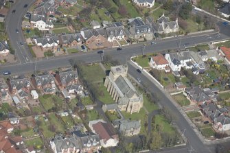 Oblique aerial view of the Chapel of our Lady of the Assumption and St Meddan Church, looking NNW.