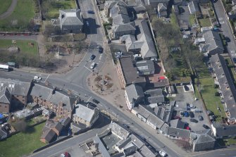 Oblique aerial view of Prestwick Market Cross, looking W.