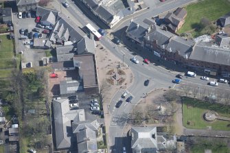 Oblique aerial view of Prestwick Market Cross, looking ENE.