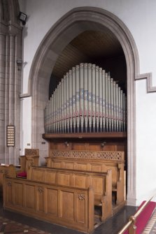 Organ loft and choir stalls from south east.