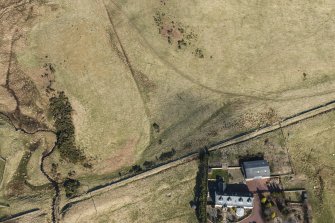 Oblique aerial view of the possible line of the Roman Road at Eight Mile Burn (NT 1930 5939), looking NNW.
