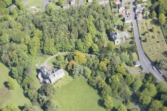 Oblique aerial view of Mid Calder Parish Church and Calder House, looking N.