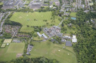 Oblique aerial view of Merchiston Castle School, including the main building and memorial hall, Colinton House, Chalmers Boarding House, Rogerson Boarding House and Laidlaw House, looking SE.