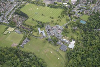 Oblique aerial view of Merchiston Castle School, including the main building and memorial hall, Colinton House, Chalmers Boarding House, Rogerson Boarding House and Laidlaw House, looking ESE.