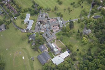 Oblique aerial view of Merchiston Castle School, including the main building and memorial hall, Colinton House, Chalmers Boarding House, Rogerson Boarding House, Engineer's Cottage and Laidlaw House, looking E.