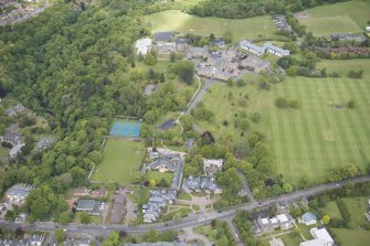 Oblique aerial view of Merchiston Castle School, including the main building and memorial hall, Colinton House, Chalmers Boarding House, Rogerson Boarding House, Engineer's Cottage, Colinton Castle, Sanatorium and Laidlaw House, looking NNW.