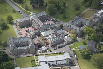 Oblique aerial view of Merchiston Castle School, including the main building and memorial hall, Chalmers Boarding House and Rogerson Boarding House, looking SW.
