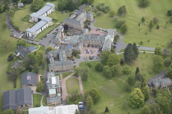 Oblique aerial view of Merchiston Castle School, including the main building and memorial hall, Chalmers Boarding House, Rogerson Boarding House and Laidlaw House and Colinton House, looking E.