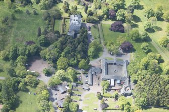 Oblique aerial view of Mortonhall House, terraced garden, stable court and granary, looking SW.