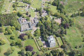 Oblique aerial view of Mortonhall House, terraced garden, stable court and granary, looking E.