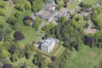 Oblique aerial view of Mortonhall House, terraced garden, stable court and granary, looking NE.