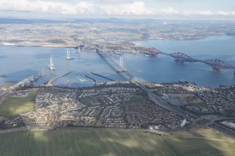 Oblique aerial view of the construction of the Queensferry Crossing, the Forth Road Bridge and the Forth Bridge, looking N.