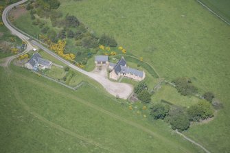 Oblique aerial view of Easter Clune House and Castle of Easter Clune, looking NW.