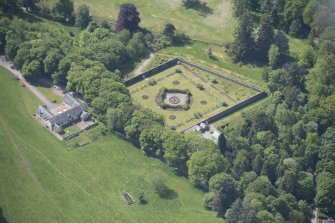 Oblique aerial view of Ballindalloch Castle walled garden and stables, looking SW.