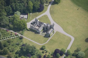 Oblique aerial view of Ballindalloch Castle, looking E.