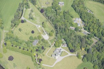 Oblique aerial view of Ballindalloch Castle and dovecot, looking NNE.