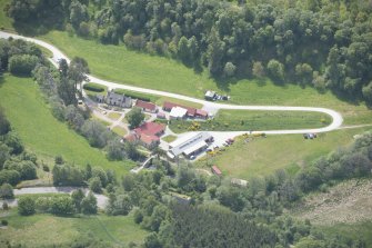 Oblique aerial view of Knockando Woollen Mill, looking S.