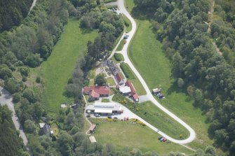 Oblique aerial view of Knockando Woollen Mill, looking SSE.