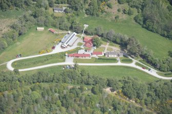 Oblique aerial view of Knockando Woollen Mill, looking NE.