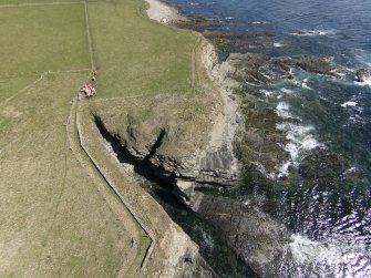 Oblique aerial view of the remains of Verron broch, looking ESE.