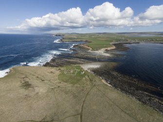 Oblique aerial view of the chapel and settlement at Brough of Birsay, looking ESE.