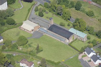 Oblique aerial view of the Holy Family Roman Catholic Church, looking NNW.