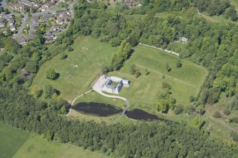Oblique aerial view of Dougalston Factor's House, looking NW.