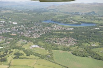 Oblique aerial view of Milngavie, Craigmaddie and Mugdock Reservoirs, looking N.