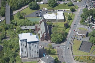 Oblique aerial view of St Lawrence's Roman Catholic Church and Presbytery, looking NW.